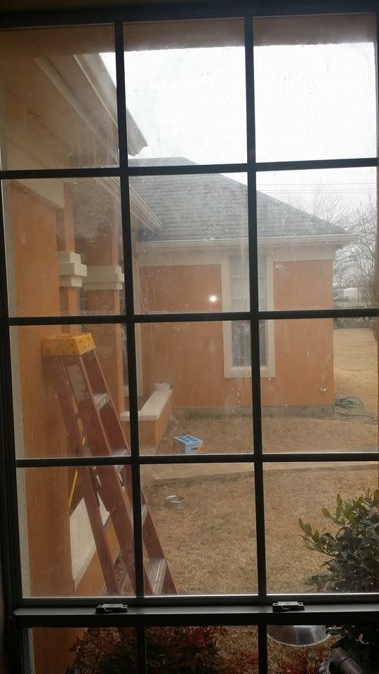 Window glass before replacement, showing haze and reduced clarity