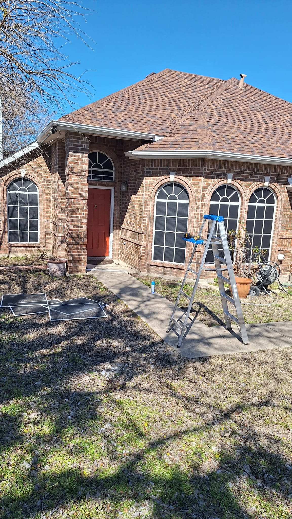 Clearwater solar screen and window glass work at a brick home